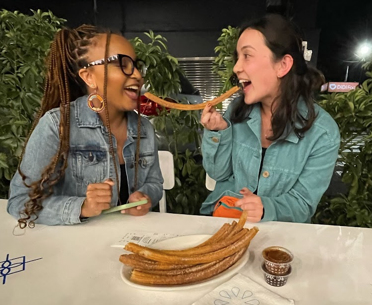 Two women eating churros in Mexico City