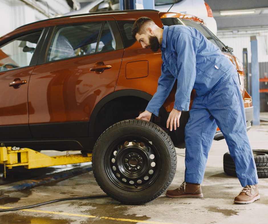 Mechanic checking car tire